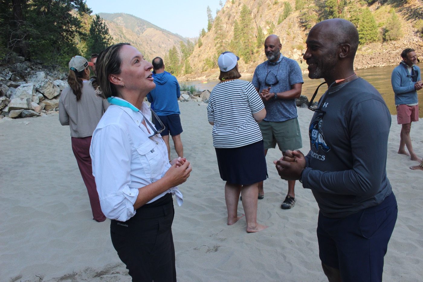 Participants talking and laughing on the beach