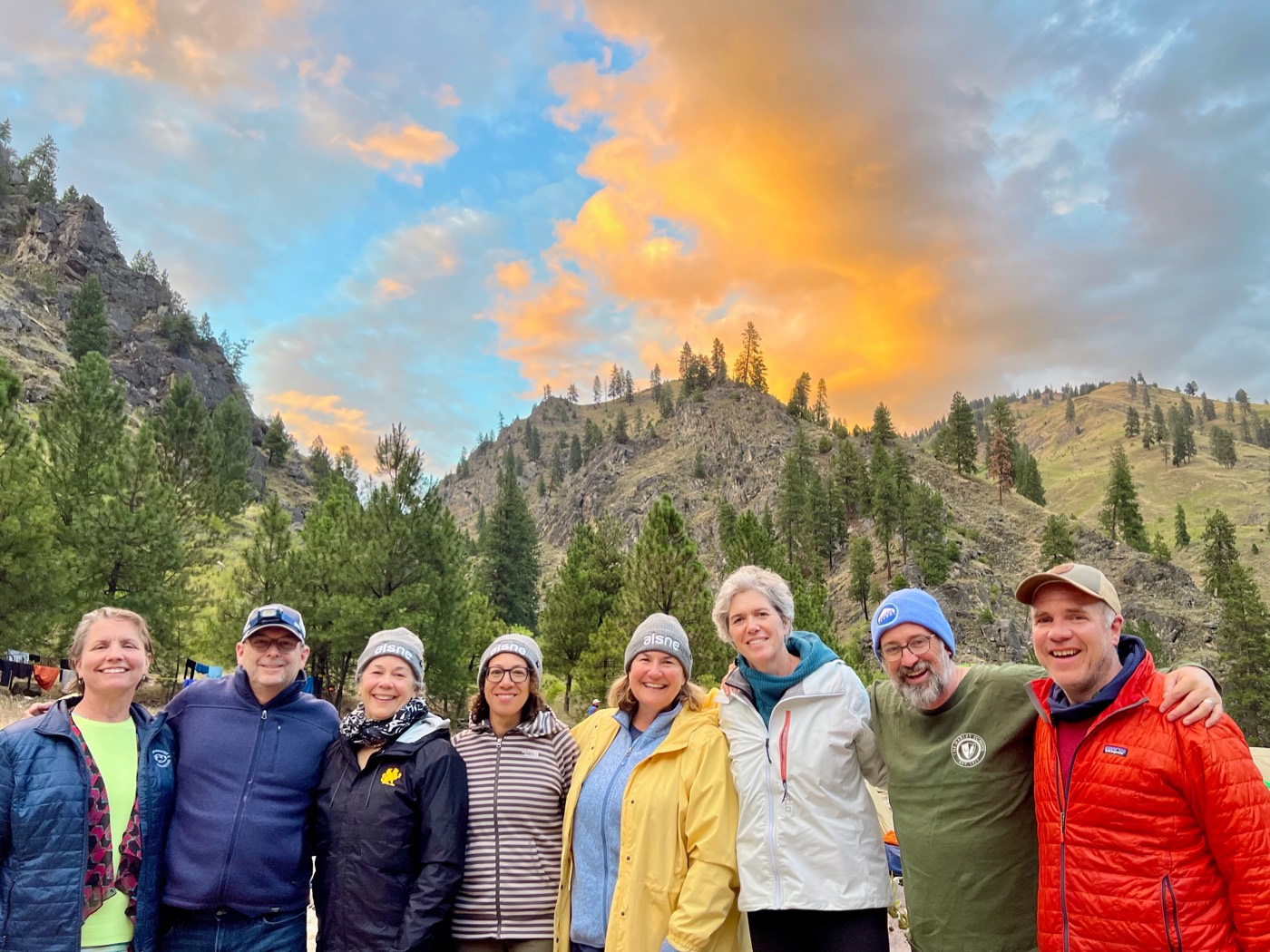 A group of heads of school beneath a sunset sky in the Salmon River canyon