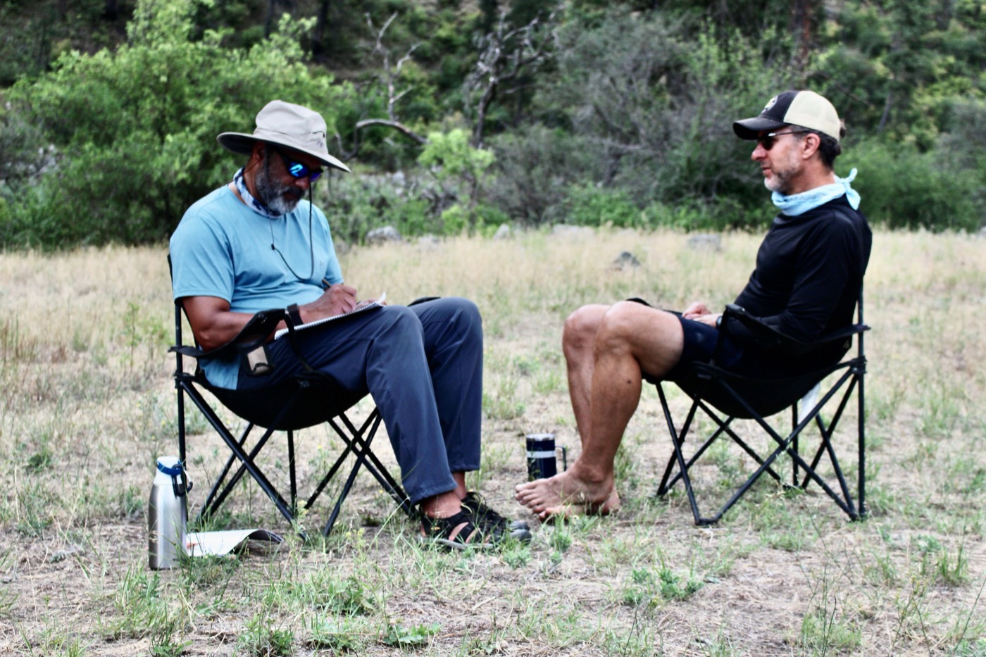 Two participants in camp chairs during a one-on-one conversation