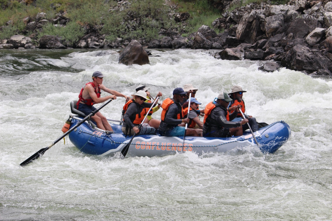 A raft of heads of school running rapids on the Salmon River
