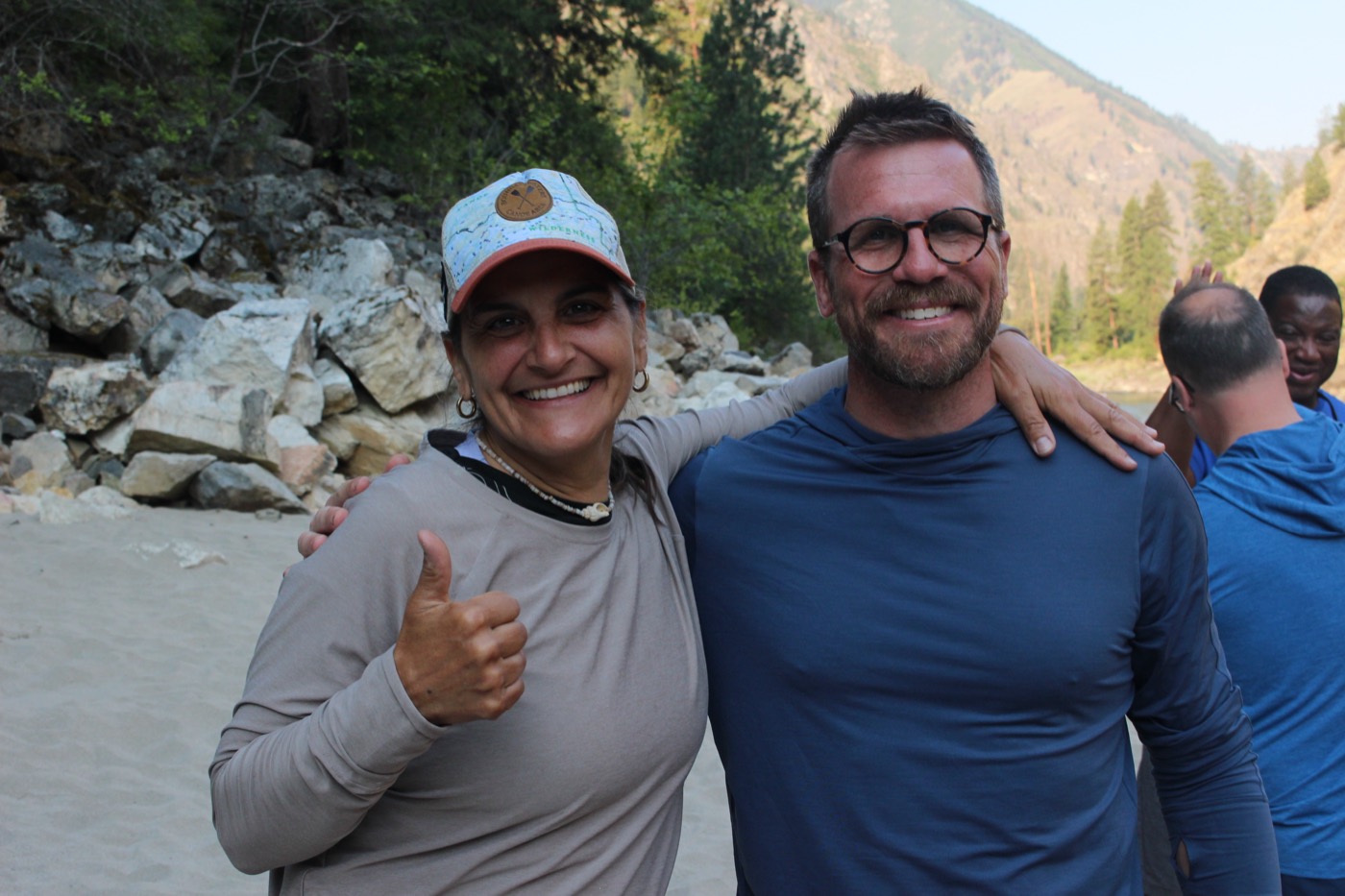 Two smiling participants on the beach
