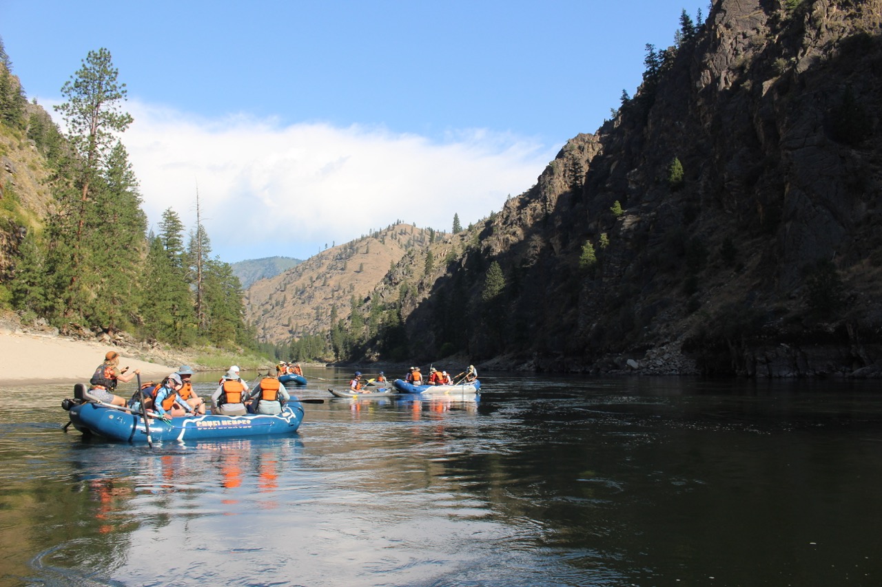 Rafts on a calm stretch of the Salmon River below a canyon wall